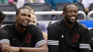 Oct 13, 2015; Orlando, FL, USA; Miami Heat forward Chris Bosh (left) and guard Dwyane Wade (right) smile and laugh on the bench against the Orlando Magic during the second half at Amway Center. Orlando Magic defeated the Miami Heat 95-92 in overtime. Mandatory Credit: Kim Klement-USA TODAY Sports