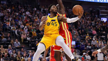 Nov 9, 2021; Salt Lake City, Utah, USA; Utah Jazz guard Donovan Mitchell (45) gets past Atlanta Hawks center Clint Capela (15) and under the basket during the third quarter at Vivint Arena. Utah Jazz won 110-98. Mandatory Credit: Chris Nicoll-USA TODAY Sports
