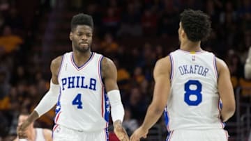 Feb 26, 2016; Philadelphia, PA, USA; Philadelphia 76ers forward Nerlens Noel (4) celebrates with center Jahlil Okafor (8) after a score against the Washington Wizards during the second quarter at Wells Fargo Center. Mandatory Credit: Bill Streicher-USA TODAY Sports