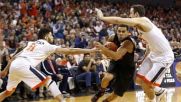 Jan 12, 2016; Charlottesville, VA, USA; Miami Hurricanes guard Angel Rodriguez (13) drives to the basket as Virginia Cavaliers guard Darius Thompson (51) and Cavaliers forward Evan Nolte (11) defend in the first half at John Paul Jones Arena. The Cavaliers won 66-58. Mandatory Credit: Geoff Burke-USA TODAY Sports