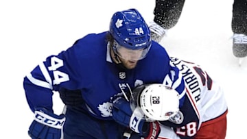 Morgan Rielly #44 of the Toronto Maple Leafs puts Oliver Bjorkstrand #28 of the Columbus Blue Jackets in a headlock. (Photo by Andre Ringuette/Freestyle Photo/Getty Images)