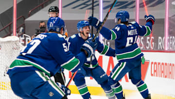 VANCOUVER, BC - JANUARY 20: Tyler Motte #64 of the Vancouver Canucks celebrates with teammates Jay Beagle #83 and Tyler Myers #57 after scoring a goal against the Montreal Canadiens during NHL hockey action at Rogers Arena on January 20, 2021 in Vancouver, Canada. (Photo by Rich Lam/Getty Images)