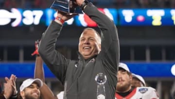 Dec 30, 2014; Charlotte, NC, USA; Georgia Bulldogs head coach Mark Richt holds up the trophy after after defeating the Louisville Cardinals. Georgia defeated Louisville 37-14 in the Belk Bowl held at Bank of America Stadium. Mandatory Credit: Jeremy Brevard-USA TODAY Sports