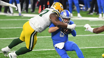 DETROIT, MICHIGAN - DECEMBER 13: Kenny Clark #97 of the Green Bay Packers tackles Matthew Stafford #9 of the Detroit Lions during the second half at Ford Field on December 13, 2020 in Detroit, Michigan. (Photo by Nic Antaya/Getty Images)
