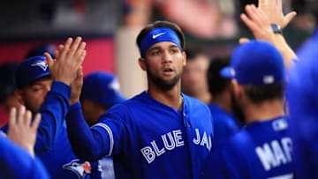 ANAHEIM, CA - JUNE 21: Lourdes Gurriel Jr. #13 is congratulated in the dugout after scoring on a double by Justin Smoak #14 of the Toronto Blue Jays during the third inning of a game against the Los Angeles Angels of Anaheim at Angel Stadium on June 21, 2018 in Anaheim, California. (Photo by Sean M. Haffey/Getty Images)