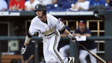 Jun 24, 2015; Omaha, NE, USA; Vanderbilt Commodores shortstop Dansby Swanson (7) hits an rbi ground out during the first inning against the Virginia Cavaliers in game three of the College World Series Finals at TD Ameritrade Park. Mandatory Credit: Bruce Thorson-USA TODAY Sports