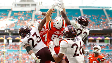 MIAMI, FLORIDA - OCTOBER 05: Will Mallory #85 of the Miami Hurricanes tips a pass that would be caught by Mark Pope #6 for a touchdown against the Virginia Tech Hokies during the first half at Hard Rock Stadium on October 05, 2019 in Miami, Florida. (Photo by Michael Reaves/Getty Images)