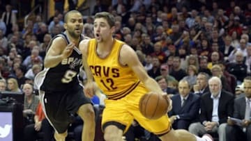 Nov 19, 2014; Cleveland, OH, USA; Cleveland Cavaliers guard Joe Harris (12) drives against San Antonio Spurs guard Tony Parker (9) in the second quarter at Quicken Loans Arena. Mandatory Credit: David Richard-USA TODAY Sports