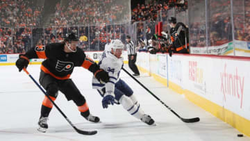 PHILADELPHIA, PENNSYLVANIA - NOVEMBER 02: Tyson Barrie #94 of the Toronto Maple Leafs carries the puck around Kevin Hayes #13 of the Philadelphia Flyers during the first period at the Wells Fargo Center on November 02, 2019 in Philadelphia, Pennsylvania. (Photo by Bruce Bennett/Getty Images)