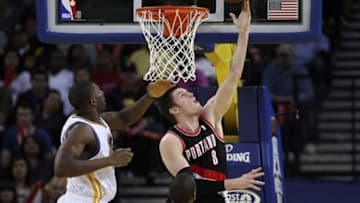 Mar 30, 2013; Oakland, CA, USA; Portland Trail Blazers small forward Luke Babbitt (8) goes up for the layup against Golden State Warriors center Festus Ezeli (31) during the third quarter at Oracle Arena. The Golden State Warriors defeated the Portland Trail Blazers 125-98. Mandatory Credit: Kelley L Cox-USA TODAY Sports