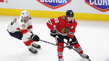 CHICAGO, ILLINOIS - MARCH 23: Patrick Kane #88 of the Chicago Blackhawks looks to pass under pressure from Noel Acciari #55 of the Florida Panthers at the United Center on March 23, 2021 in Chicago, Illinois. (Photo by Jonathan Daniel/Getty Images)