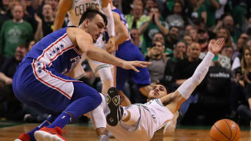 BOSTON - JANUARY 18: Boston Celtics' Shane Larkin falls to the floor as he battles 76ers' Dario Saric for a loose ball in the fourth quarter. The Boston Celtics host the Philadelphia 76ers in a regular season NBA basketball game at TD Garden in Boston on Jan. 18, 2018. (Photo by John Tlumacki/The Boston Globe via Getty Images)