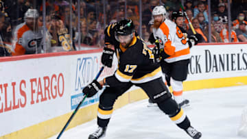 PHILADELPHIA, PENNSYLVANIA - OCTOBER 20: Nick Foligno #17 of the Boston Bruins clears the puck against the Philadelphia Flyers at Wells Fargo Center on October 20, 2021 in Philadelphia, Pennsylvania. (Photo by Tim Nwachukwu/Getty Images)