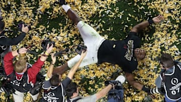 Jan 11, 2016; Glendale, AZ, USA; Alabama Crimson Tide linebacker Reggie Ragland celebrates with snow angle in the middle of the field following their 45-40 victory over the Clemson Tigers in the 2016 CFP National Championship at University of Phoenix Stadium. Mandatory Credit: Erich Schlegel-USA TODAY Sports