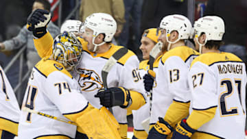 Nashville Predators goaltender Juuse Saros (74) celebrates with center Ryan Johansen (92) after defeating the New Jersey Devils in overtime at Prudential Center. Mandatory Credit: Vincent Carchietta-USA TODAY Sports