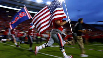 OXFORD, MS - OCTOBER 21: The Mississippi Rebels carry an American flag as they take the field before a game against the LSU Tigers at Vaught-Hemingway Stadium on October 21, 2017 in Oxford, Mississippi. (Photo by Jonathan Bachman/Getty Images)