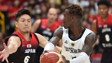 OKC Thunder: Germany's point guard Dennis Schroder (C) keeps the ball against Japan's Makoto Hiejima (Photo by Kazuhiro NOGI / AFP) (Photo credit should read KAZUHIRO NOGI/AFP/Getty Images)