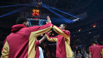 Evan Mobley (right) greets his Cleveland Cavaliers teammates before a game. (Photo by Jason Miller/Getty Images)