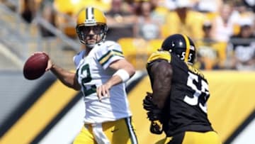 Aug 23, 2015; Pittsburgh, PA, USA; Green Bay Packers quarterback Aaron Rodgers (12) looks to pass against pressure from Pittsburgh Steelers outside linebacker Arthur Moats (55) during the first quarter at Heinz Field. Mandatory Credit: Charles LeClaire-USA TODAY Sports