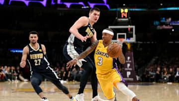 LOS ANGELES, CA - MARCH 13: Isaiah Thomas #3 of the Los Angeles Lakers gets around Nikola Jokic #15 of the Denver Nuggets on March 13, 2018 at STAPLES Center in Los Angeles, California. NOTE TO USER: User expressly acknowledges and agrees that, by downloading and or using this photograph, User is consenting to the terms and conditions of the Getty Images License Agreement.  (Photo by Robert Laberge/Getty Images)
