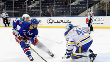 NEW YORK, NEW YORK - MARCH 02:Sabres makes the third period save on Chris Kreider #20 of the New York Rangers (Photo by Bruce Bennett/Getty Images)
