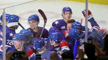 Amerks Arttu Ruotsalainen is mobbed by teammates after scoring the game winning goal in OT to beat Utica 4-3.