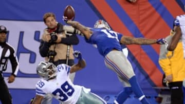 Nov 23, 2014; East Rutherford, NJ, USA; New York Giants wide receiver Odell Beckham (13) catches a one handed touchdown against by Dallas Cowboys cornerback Brandon Carr (39) during the second quarter at MetLife Stadium. Mandatory Credit: Robert Deutsch-USA TODAY Sports