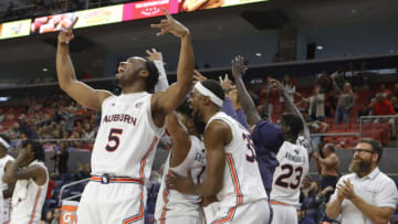 Dec 4, 2021; Auburn, Alabama, USA; Auburn Tigers forward Chris Moore (5) and players on the bench react to a late 3-point shot late in the second half against the Yale Bulldogs at Auburn Arena. Mandatory Credit: John Reed-USA TODAY Sports