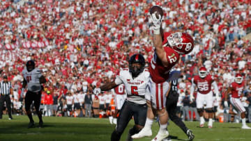 Oklahoma's Drake Stoops (12) catches a pass for a touchdown in front of Texas Tech's Riko Jeffers (6) during a college football game between the University of Oklahoma Sooners (OU) and the Texas Tech Red Raiders at Gaylord Family-Oklahoma Memorial Stadium in Norman, Okla., Saturday, Oct. 30, 2021.Ou Vc Texas Tech