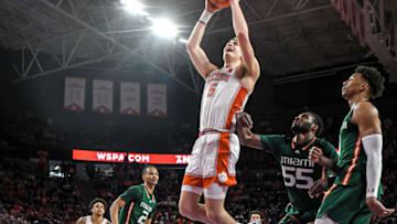 Feb 4, 2023; Clemson, South Carolina, USA; Clemson forward Hunter Tyson (5) shoots near Miami guard Isaiah Wong (2) during the second half at Littlejohn Coliseum in Clemson, S.C. Saturday, Feb. 4, 2023. Mandatory Credit: Ken Ruinard-USA TODAY Sports