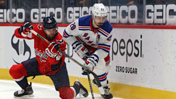 WASHINGTON, DC - FEBRUARY 20: Chris Kreider #20 of the New York Rangers skates past Evgeny Kuznetsov #92 of the Washington Capitals during the third period at Capital One Arena on February 20, 2021 in Washington, DC. (Photo by Patrick Smith/Getty Images)