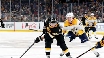 BOSTON, MA - DECEMBER 21: Boston Bruins left wing Brad Marchand (63) shields the puck from Nashville Predators center Ryan Johansen (92) during a game between the Boston Bruins and the Nashville Predators on December 21, 2019, at TD Garden in Boston, Massachusetts. (Photo by Fred Kfoury III/Icon Sportswire via Getty Images)
