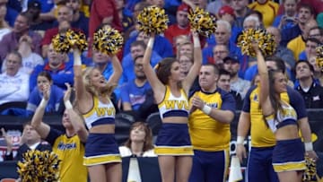 Mar 12, 2016; Kansas City, MO, USA; The West Virginia Mountaineers cheerleaders celebrate after a score against the Kansas Jayhawks in the championship game of the Big 12 Conference tournament at Sprint Center. Kansas Won 81-71. Mandatory Credit: Denny Medley-USA TODAY Sports