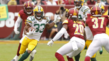 Oct 23, 2022; Landover, Maryland, USA; Green Bay Packers running back Aaron Jones (33) carries the ball as Washington Commanders safety Bobby McCain (20) chases during the third quarter at FedExField. Mandatory Credit: Geoff Burke-USA TODAY Sports