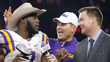 Dec 29, 2015; Houston, TX, USA; MVP LSU Tigers running back Leonard Fournette (7) and head coach Les Miles talks to a reporter after defeating the Texas Tech Red Raiders at NRG Stadium. LSU won 56 to 27. Mandatory Credit: Thomas B. Shea-USA TODAY Sports