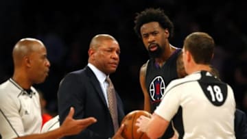 Jan 22, 2016; New York, NY, USA; Los Angeles Clippers head coach Doc Rivers and Los Angeles Clippers center DeAndre Jordan (6) talk to referee Dedric Taylor (21) and referee Matt Boland (18) during second half against New York Knicks at Madison Square Garden. Mandatory Credit: Noah K. Murray-USA TODAY Sports