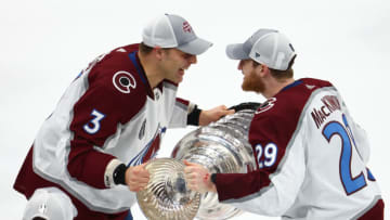 Jun 26, 2022; Tampa, Florida, USA; Colorado Avalanche center Nathan MacKinnon (29) and defenseman Jack Johnson (3) celebrate with the Stanley Cup trophy after defeating the Tampa Bay Lightning during game six of the 2022 Stanley Cup Final at Amalie Arena. Mandatory Credit: Mark J. Rebilas-USA TODAY Sports
