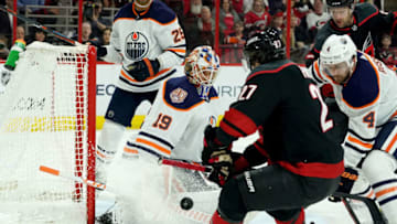 RALEIGH, NC - FEBRUARY 15: Justin Faulk #27 of the Carolina Hurricanes looks to chip a puck past Mikko Koskinen #19 of the Edmonton Oilers during an NHL game on February 15, 2019 at PNC Arena in Raleigh, North Carolina. (Photo by Gregg Forwerck/NHLI via Getty Images)