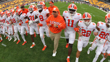 Oct 23, 2021; Pittsburgh, Pennsylvania, USA; Clemson Tigers head coach Dabo Swinney (middle) and the Tigers take the field to warm up before the game against the Pittsburgh Panthers at Heinz Field. Mandatory Credit: Charles LeClaire-USA TODAY Sports