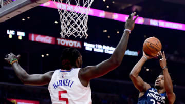 LOS ANGELES, CA - DECEMBER 06: Jimmy Butler #23 of the Minnesota Timberwolves scores over Montrezl Harrell #5 of the LA Clippers during the first half at Staples Center on December 6, 2017 in Los Angeles, California. (Photo by Harry How/Getty Images)