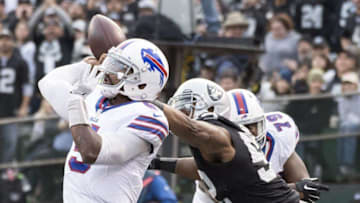 December 4, 2016; Oakland, CA, USA; Buffalo Bills quarterback Tyrod Taylor (5) passes the football defended by Oakland Raiders defensive end Khalil Mack (52) during the fourth quarter at Oakland Coliseum. The Raiders defeated the Bills 38-24. Mandatory Credit: Kyle Terada-USA TODAY Sports
