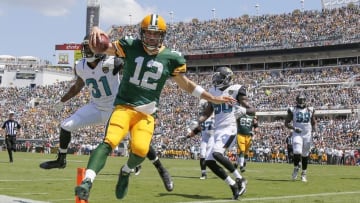 Sep 11, 2016; Jacksonville, FL, USA;Green Bay Packers quarterback Aaron Rodgers (12) runs the ball in for a touchdown as Jacksonville Jaguars cornerback Davon House (31) attempted to defend during the first quarter at EverBank Field. Mandatory Credit: Kim Klement-USA TODAY Sports