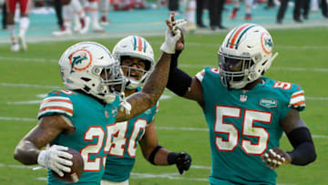 MIAMI GARDENS, FLORIDA - DECEMBER 13: Xavien Howard #25 of the Miami Dolphins celebrates his interception with Nik Needham #40 and Jerome Baker #55 against the Kansas City Chiefs during the second half of the game at Hard Rock Stadium on December 13, 2020 in Miami Gardens, Florida. (Photo by Mark Brown/Getty Images)