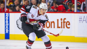 Oct 5, 2016; Calgary, Alberta, CAN; Arizona Coyotes center Dylan Strome (20) controls the puck against Calgary Flames during the second period during a preseason hockey game at Scotiabank Saddledome. Mandatory Credit: Sergei Belski-USA TODAY Sports
