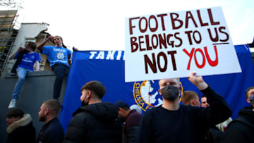 LONDON, ENGLAND - APRIL 20: Fans hold banners opposing Chelsea signing up for the newly proposed European Super League ahead of the Premier League match between Chelsea and Brighton & Hove Albion at Stamford Bridge on April 20, 2021 in London, England. Sporting stadiums around the UK remain under strict restrictions due to the Coronavirus Pandemic as Government social distancing laws prohibit fans inside venues resulting in games being played behind closed doors. (Photo by Chloe Knott - Danehouse/Getty Images)