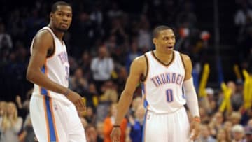 Jan 16, 2015; Oklahoma City, OK, USA; Oklahoma City Thunder forward Kevin Durant (35) and Oklahoma City Thunder guard Russell Westbrook (0) reacts after a play against the Golden State Warriors during the fourth quarter at Chesapeake Energy Arena. Mandatory Credit: Mark D. Smith-USA TODAY Sports