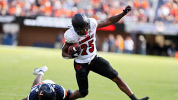 CHARLOTTESVILLE, VA - OCTOBER 08: Anthony Johnson #3 of the Virginia Cavaliers tackles Jawhar Jordan #25 of the Louisville Cardinals in the second half during a game at Scott Stadium on October 8, 2022 in Charlottesville, Virginia. (Photo by Ryan M. Kelly/Getty Images)