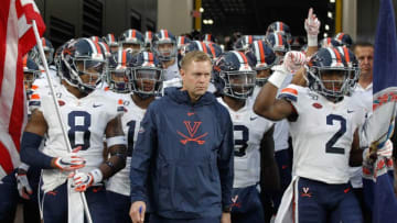 Aug 31, 2019; Pittsburgh, PA, USA; Virginia Cavaliers wide receiver Hasise Dubois (8) and head coach Bronco Mendenhall (center) and wide receiver Joe Reed (2) lead the team onto the field to play the Pittsburgh Panthers at Heinz Field. Virginia won 30-14. Mandatory Credit: Charles LeClaire-USA TODAY Sports