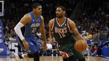 Jan 31, 2014; Orlando, FL, USA; Milwaukee Bucks shooting guard Gary Neal (12) dribbles the ball as Orlando Magic small forward Tobias Harris (12) defends during the second quarter at Amway Center. Mandatory Credit: Kim Klement-USA TODAY Sports