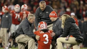 Nov 15, 2014; Athens, GA, USA; Georgia Bulldogs head coach Mark Richt and training staff tend to running back Todd Gurley (3) after an injury in the fourth quarter of their game against the Auburn Tigers at Sanford Stadium. Georgia won 34-7. Mandatory Credit: Jason Getz-USA TODAY Sports